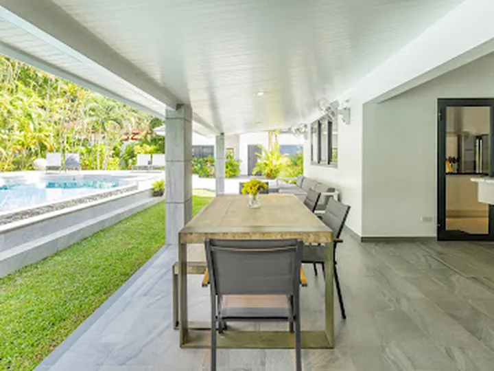 Covered outdoor dining beside the pool